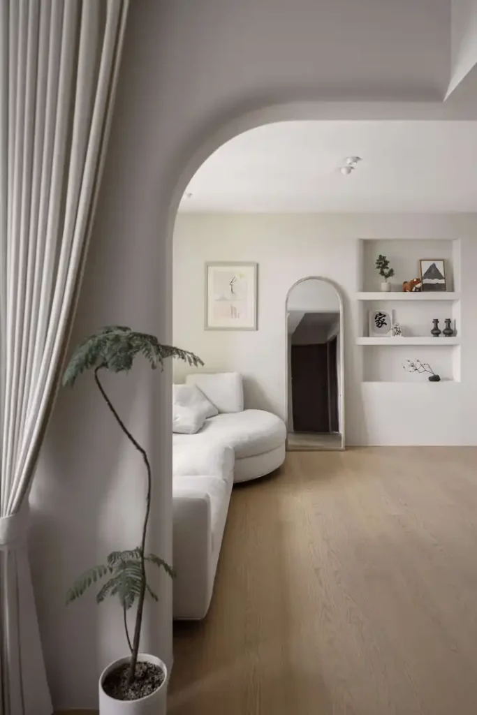 Japandi living room with soft white sofa, archway and neutral palette in Kuala Lumpur condo