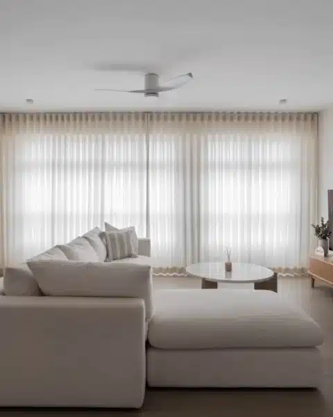 Minimalist Scandinavian living room with chaise sofa, full-height curtains and wood flooring in Malaysia