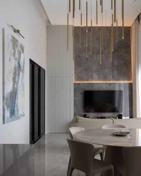 Modern luxury living room with double-volume ceiling, statement lighting and marble TV wall by Lemonfridge Studio in Kuala Lumpur.